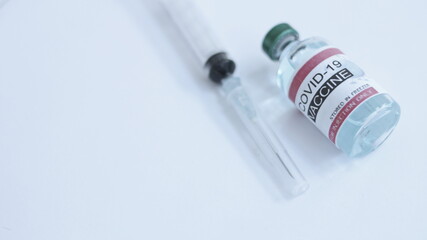 Coronavirus or COVID-19, 2019 - nCoV vaccine in a bottle with syringe,vaccine vial with physician supplies in background