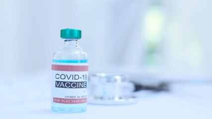 Coronavirus or COVID-19, 2019 - nCoV vaccine in a bottle with syringe,vaccine vial with physician supplies in background