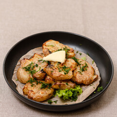 Vegan cuisine: Grilled young potatoes with rosemary in a pan