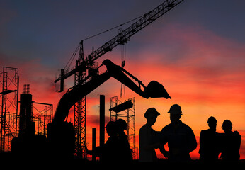 Silhouette engineer standing orders for construction crews and Excavator and machinery in an...