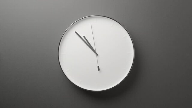 Clock Face on Dark Grey Office Wall in Timelapse