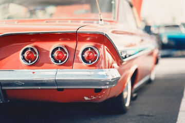 Classic car show, close-up on vehicle taillights, vintage color
