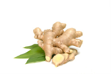 Fresh ginger rhizome with sliced and green leaves isolated on white