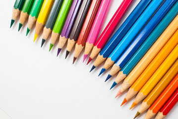 Top view Colored pencils. Different colors are placed alternately on a white background. Ready to use in school supplies, offices, packaging, and advertising