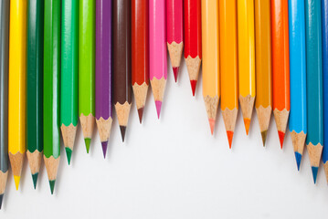 Colored pencils. Various colors are placed alternately on a white background. Ready to use in school materials, office, packaging, and advertising
