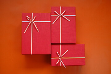 Cristmas presents. Surprises and gifts for the winter holidays.  Red boxes set  on a red background.Merry Christmas.