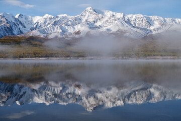 Altai lake Dzhangyskol on mountain plateau Eshtykel. Morning fog over water. Altai, Siberia, Russia