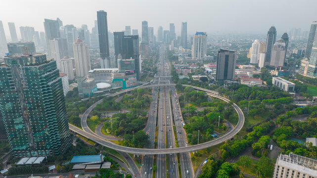 Aerial view of the city traffics at semanggi Roundabout, Jakarta, Indonesia. Aerial view on highways and skyscrapers with noise cloud. Jakarta, Indonesia