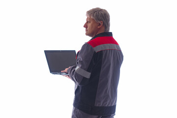 Computer engineer on a light background. He works with a laptop in his hands. Computer engineer in gray work uniform. Concept - advertising computer engineer. Electronics repair services