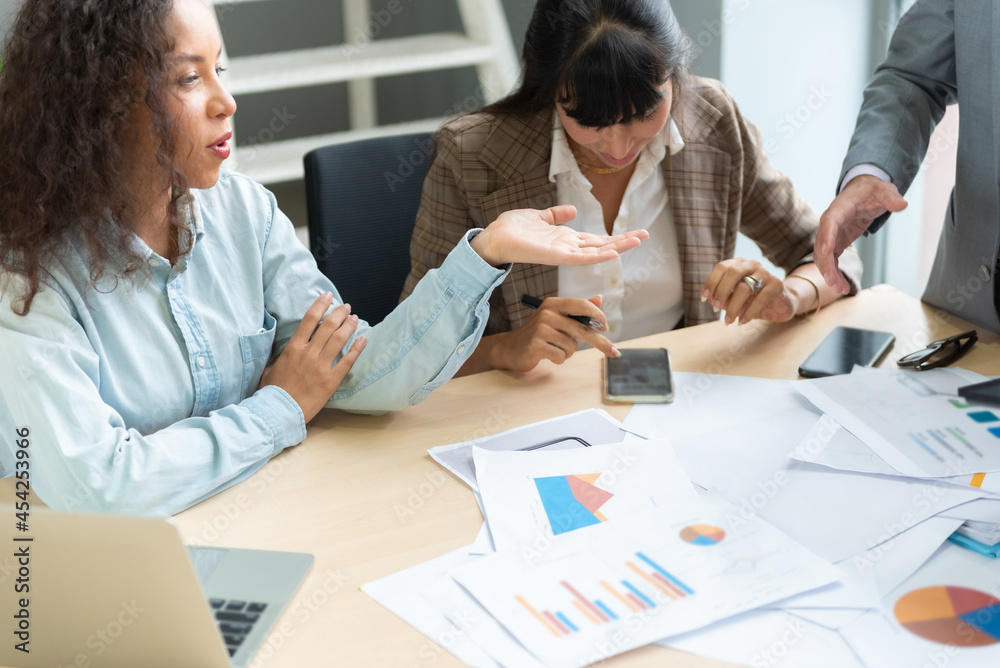 Wall mural Group of employees discussing financial statistics.