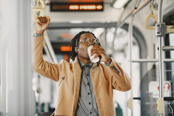 Fototapeta na wymiar Young African businessman standing on a bus