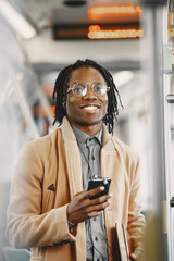 Young African businessman standing in a bus