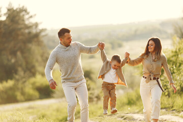 Fototapeta premium Cute family playing in a summer field