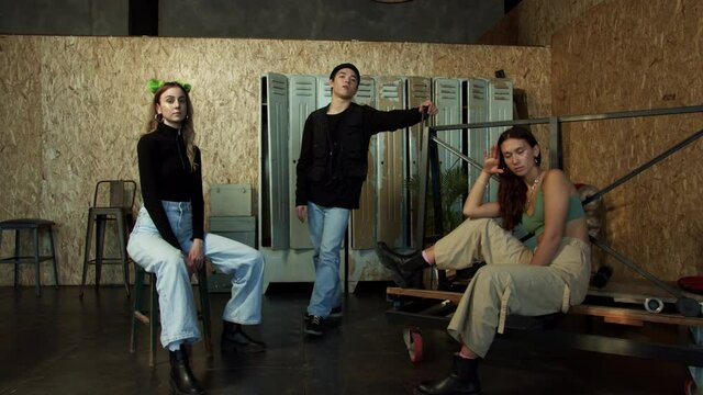 Young modern persons pose isolated in a sports locker room