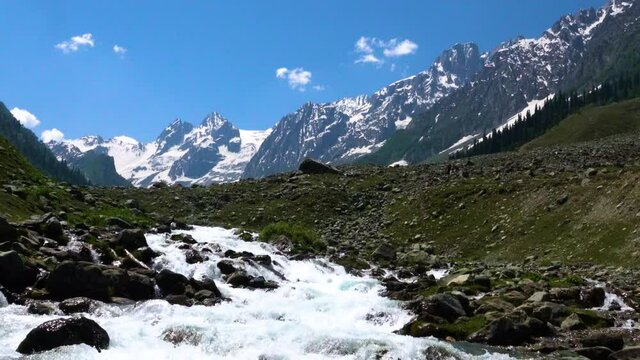 Beautiful mountain scenery. Blue sky, clear river with rocks. In-depth trip on the Sonamarg Hill Trek in Jammu and Kashmir, India, June 2018