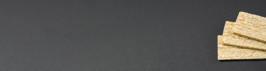 Healthy food. Airy diet loaves lie on a black background. diet food. banner for placement on the site