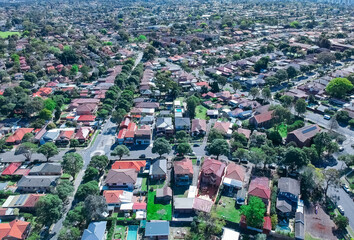 Panoramic Aerial Drone view of Suburban Sydney housing, roof tops, the streets and the parks NSW...