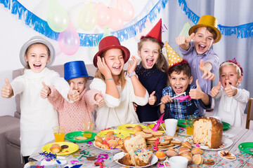happy spanish children having celebration of friend birthday during dinner
