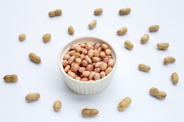 Raw peanuts on white background.