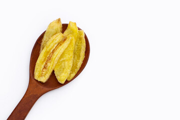 Banana slice chips in wooden spoon on white background.
