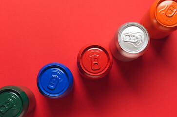 Cans of soda on color background