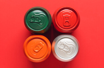 Cans of soda on color background