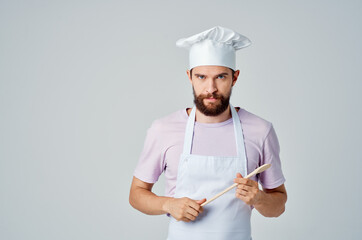 chef with wooden spoon in hand working kitchen professional