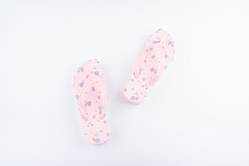 A pair of pink flower flip-flops on white background