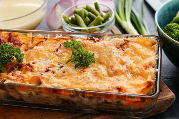 Baking dish with tasty vegetable lasagna on table, closeup