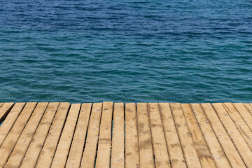 Fototapeta na wymiar blue sea and wooden pier background
