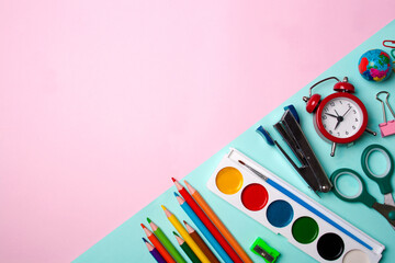 School paint items, pencils, alarm clock, scissors. View from above