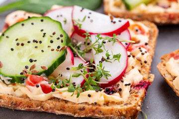 Sandwiches with cream cheese, vegetables and salami.
