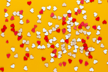 Happy Valentines day background. With small color hearts on yellow background.