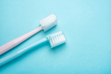 Two toothbrushes on blue background