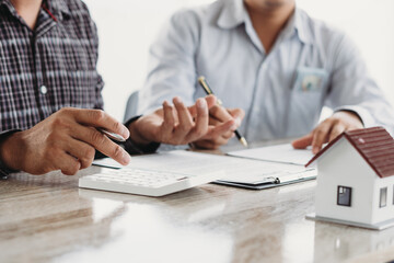 Real estate broker agent presenting and consult to customer to decision making sign insurance form...