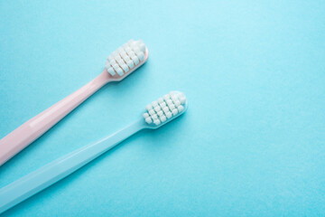 Two toothbrushes on blue background