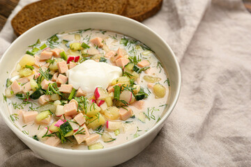 Bowl with tasty okroshka on table, closeup