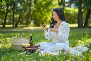 Portrait portrait of a confident mature woman. smiling woman looking at camera with big grin. Successful middle aged woman resting in the park.