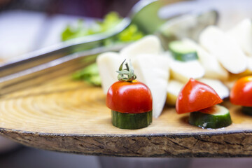 cheese, cucumber and tomatoes on plate