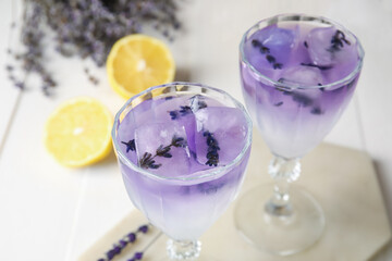 Glasses of fresh cocktail with lavender on table, closeup