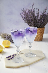 Glasses of fresh cocktail with lavender on table