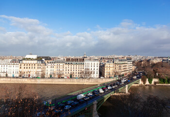 Naklejka premium Morning Traffic jam in Paris . Cars in a traffic jam on the Sully Bridge . Residential district at Ile Saint-Louis at Seine riverside in Paris 