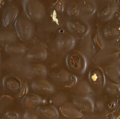 Texture, chocolate with nuts. Chocolate-drenched nuts.