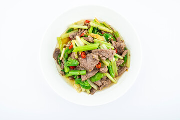 Stir-fried beef with celery on a dish on white background