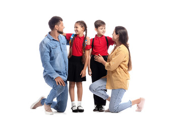 Obraz premium Little schoolchildren with their parents on white background