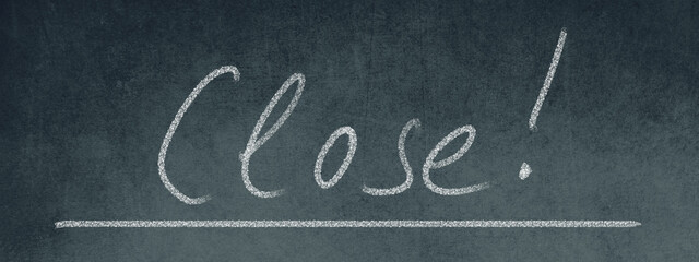 The word close standing on a blackboard, handwritten with chalk