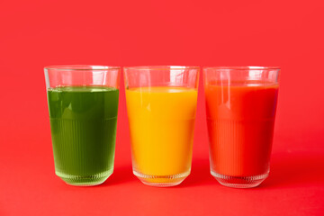 Different healthy juice on color background