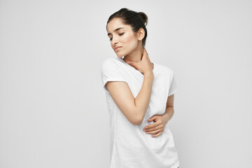 Woman in white t-shirt neck pain treatment health problem
