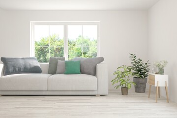 White living room with sofa and summer landscape in window. Scandinavian interior design. 3D illustration
