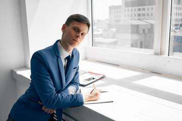 business man manager in office near window documents work